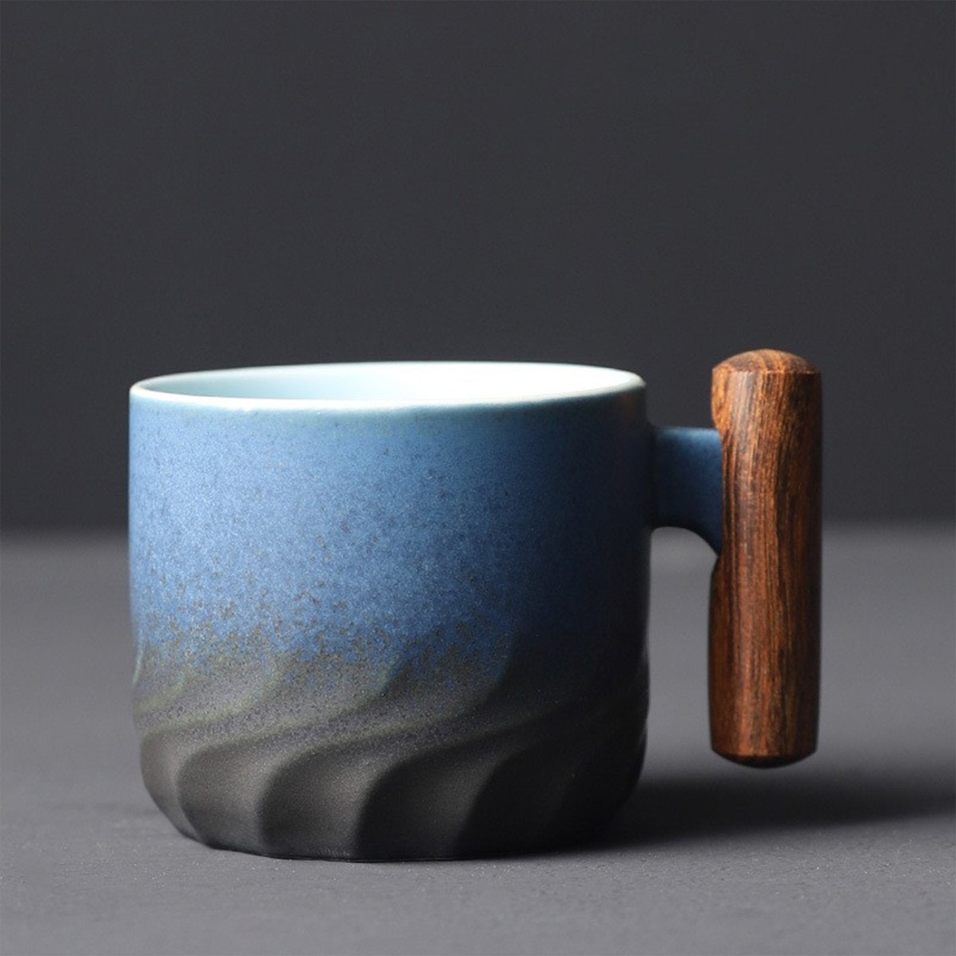 Blue ceramic mug with wooden handle, side view