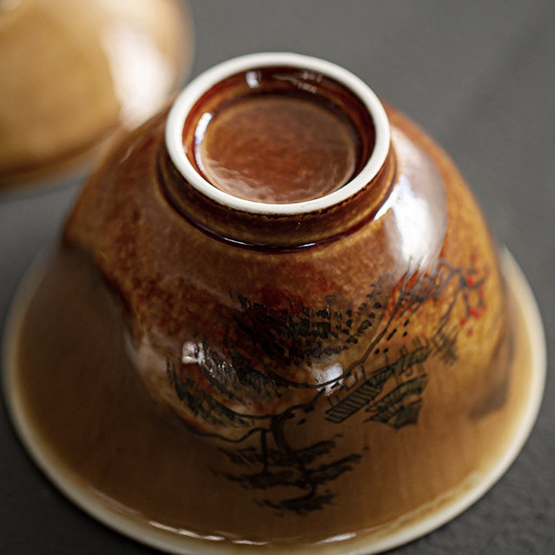 Bottom view of an inverted tea bowl showing painting details.