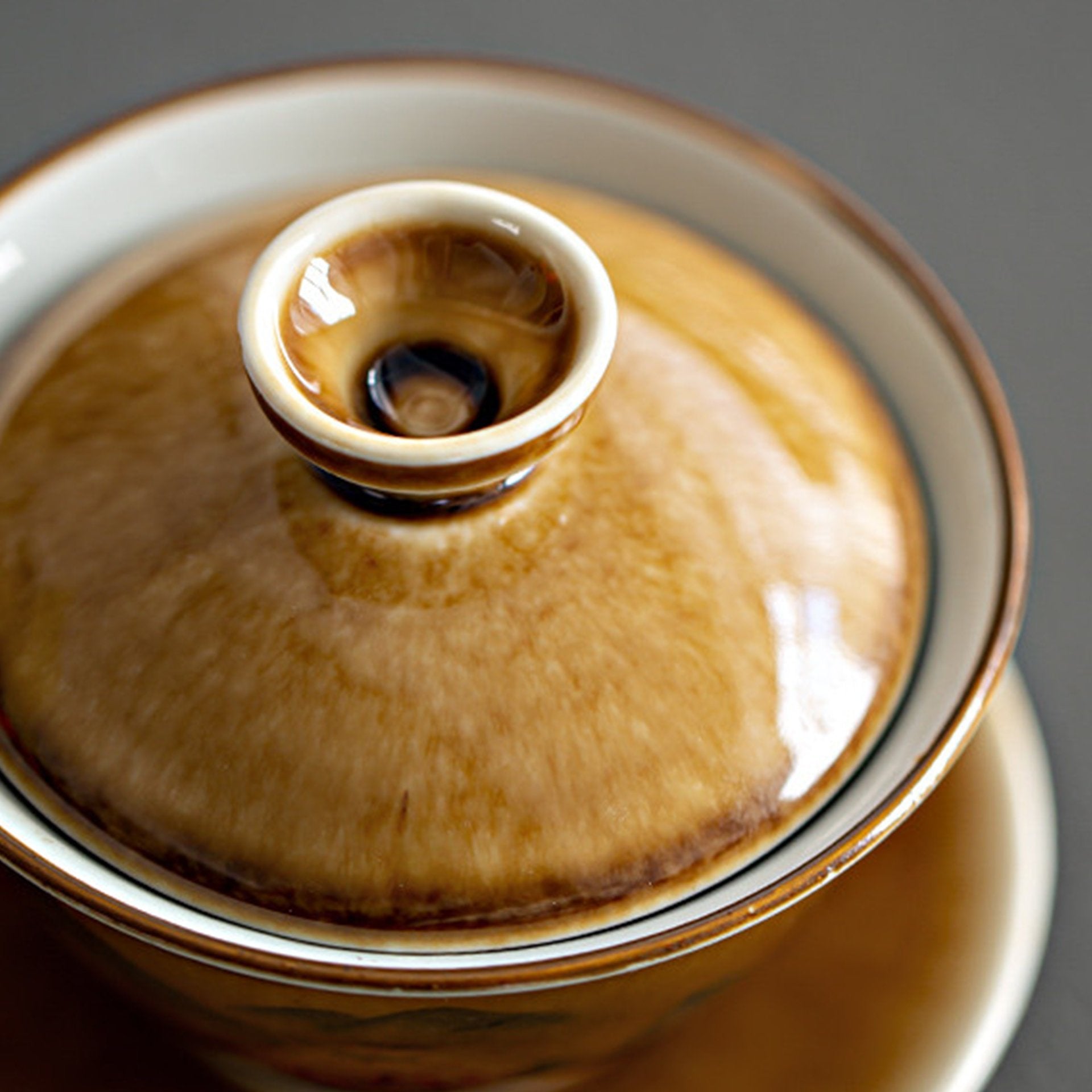 Close-up of a tea bowl lid with a circular handle.