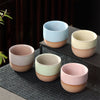 Set of four Japanese ceramic teacups in pastel tones.
