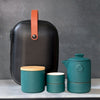 Teal tea set with wood lids and black carbon fiber-textured case with leather strap.