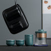 Travel tea set with glass teapot and black zippered protective case.